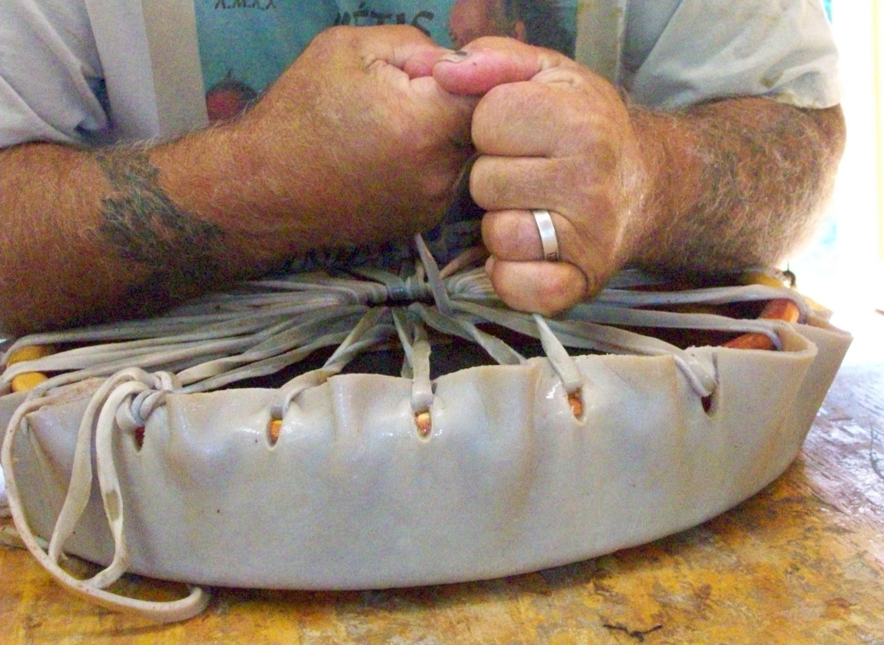 Native American Hand Drums Keith Little Badger tightens Rawhide Heads on Native American Hand Drums